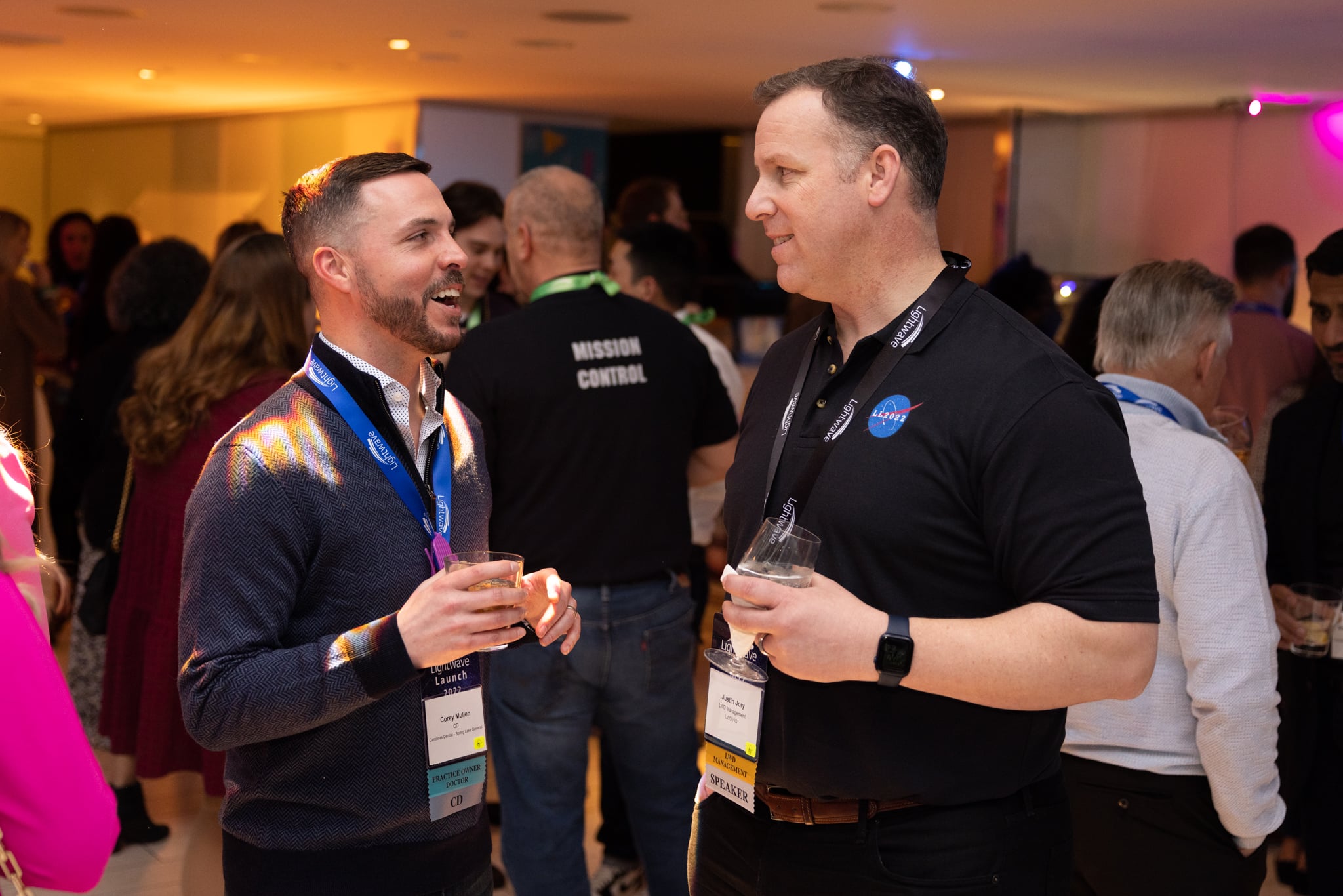 two men talking at a conference